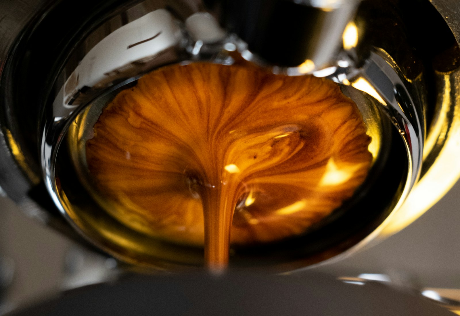 Espresso running amber through a bottomless portafilter